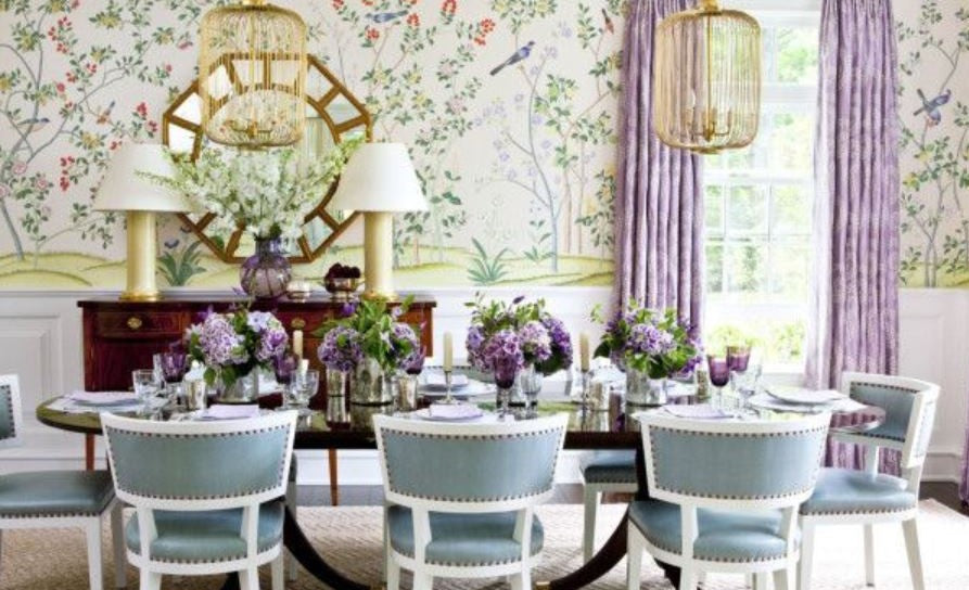 Ashley Whittaker, Dining room, floral wallpaper, lavender drapery, spring dining room, Ashley Whittaker House Beautiful dining, white table lamp, blue upholstered dining chair, white chairs, dark wood dining table, gold frame mirror, purple drapes