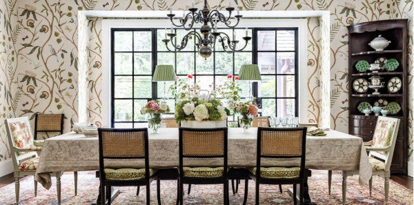dining room, dining room with wallpaper with climbing vines, veranda james farmer dining room, earth toned dining room, brass chandelier lighting, brown corner bookshelf, coordinating wallpaper and fabric, green lamps, traditional area rug