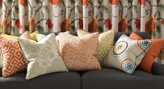 Orange throw pillows in Kravet fabrics