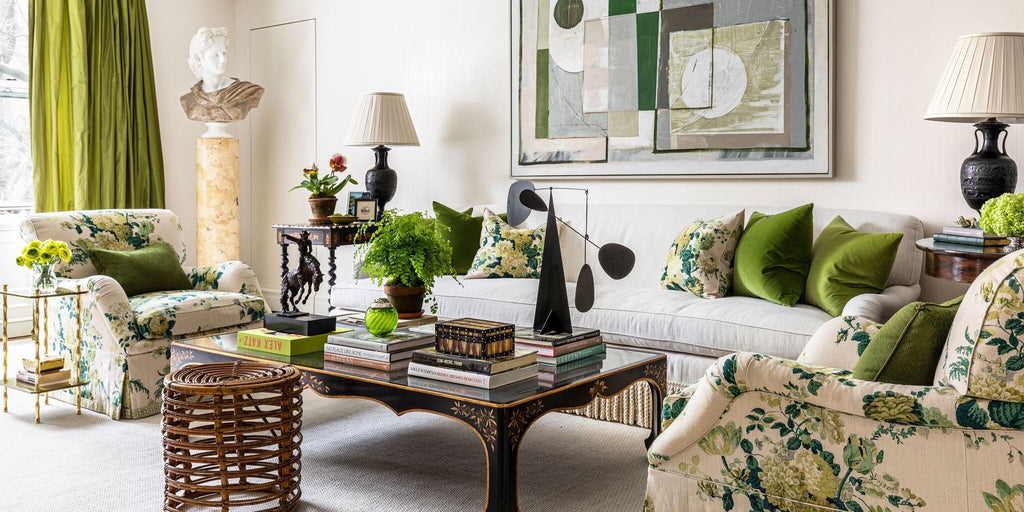 Green and yellow floral living room, lime green living room, cece barfield, veranda magazine, green drapery, green pillow, floral pillow, wood coffee table, metal table lamp, abstract wall art, rattan stool, neutral upholstery, neutral rug, statue
