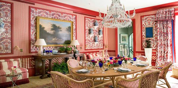 Kips Bay Dining Room in red was designed by Mark Sykes. Mixing a country look with red checks combined with a crystal chandelier creates an unforgettable room.