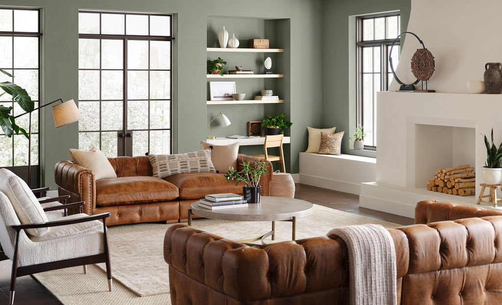 sherwin williams 2022 color evergreen fog, green living room, earth tones, earth colors, leather sofa, organic living room