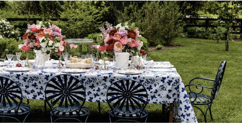 blue and white floral table cloth, outdoor table setting, wrought iron chairs