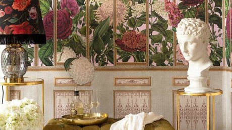 Luxury floral wallpaper with vintage botanical roses, gold trellis panels, and elegant foyer styling featuring a velvet bench, brass side tables, and classical bust decor; MINDTHEGAP The Imperial  Flora wallpaper; MTG WP20480