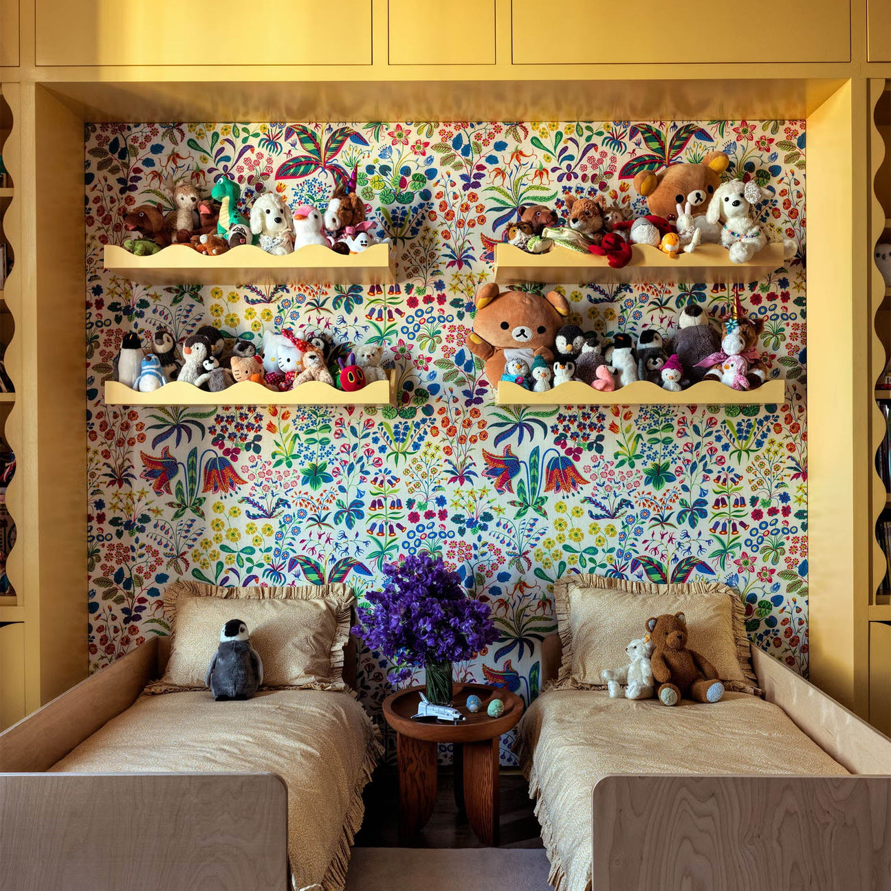 a girl's bedroom with colorful wallpaper and twin beds. schumacher canopy wallpaper