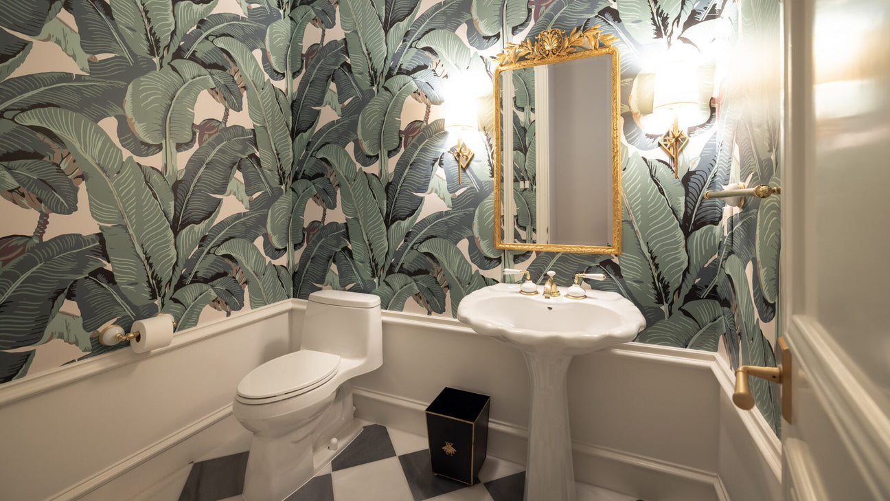 Tropical inspired bathroom with palm leaves wallpaper; Hinson Palm wallpaper; green wallpaper with oversized leaves