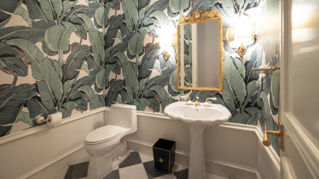 Tropical inspired bathroom with palm leaves wallpaper; Hinson Palm wallpaper; green wallpaper with oversized leaves