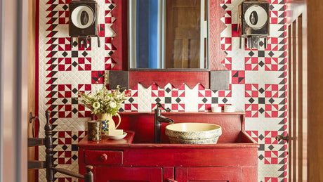 Red powder room with geometric patterned tile, rustic vanity, vessel sink,; designer anthony baratta red powder room; americana inspired powder room