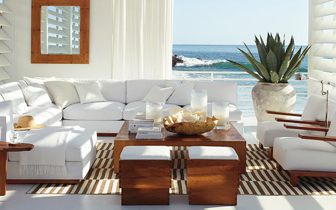 Coastal fabric white couches and chairs with white roman shades