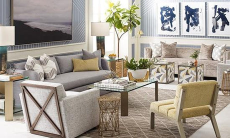 yellow side chair, white club chair, beige club chair, neutral tone living room design, tan geometric area rug, rattan side table, geometric ottomans, striped wallpaper, grey throw pillows, tan throw pillows, yellow throw pillow