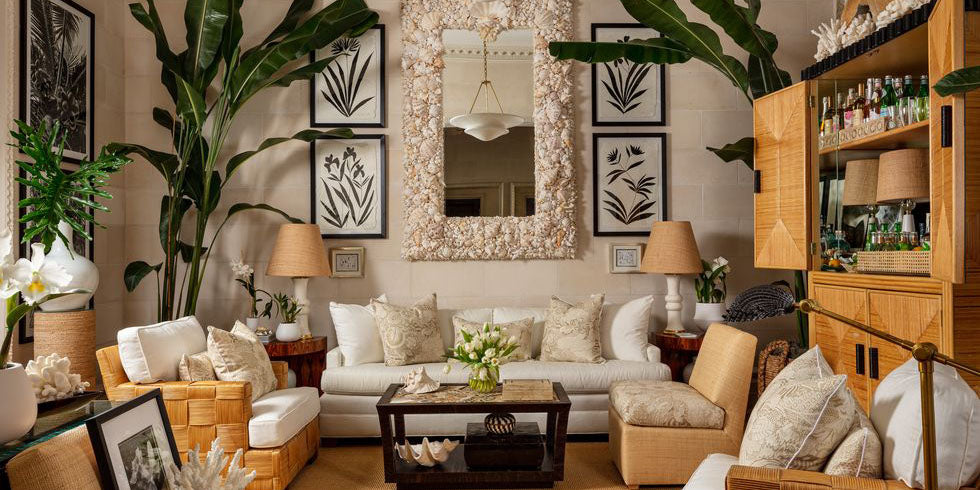 coastal den, beige den, beige family room, danielle rollins kips bay palm beach showhouse, shell mirror, rattan bar, shell framed mirror, beige toned design, black wall art, rattan accent furniture, outdoor living, metal coffee table, beige pillows