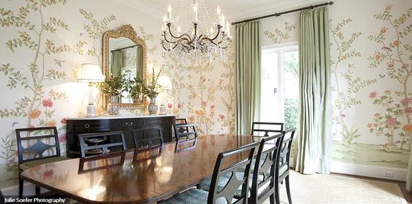 floral wallpaper dining room, Asian wallpaper dining room, chinoiserie dining room, chinoiserie wallpaper, brown dining table, brown dining chairs, tan area rug, sage draperies, gold framed mirror, brass chandelier lighting, traditional design, elle