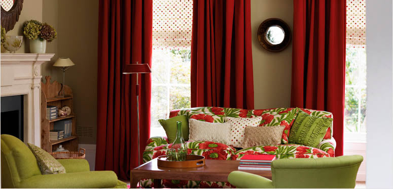 Baker Lifestyle Fabric red drapes, green floral couch with green accent chairs