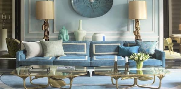 blue living room, blue velvet sofa, elle decor jean louis deniot, parisian apartment, gold coffee table, gold table lamps, blue wall art, metal candlesticks, white and blue throw pillows, blue upholstery, blue walls, blue area rug, blue decor