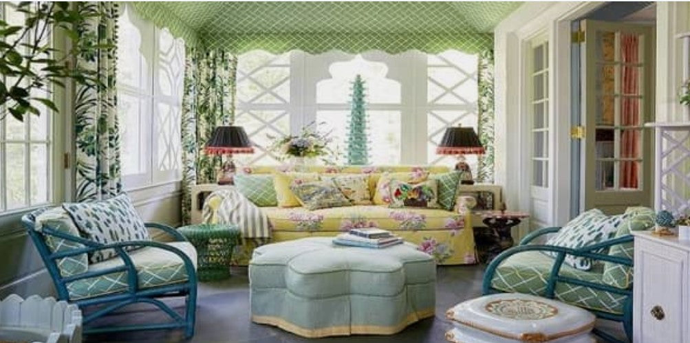 Madcap Cottage, sunroom, indoor outdoor room, porch, yellow floral sofa, wallpapered ceiling, yellow and green outdoor design, outdoor living, upholstered ottoman, blue accent chairs, green throw pillows, metal table lamps, green rattan, outdoor