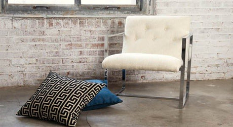 nate berkus fabrics white black blue pattern cushions chair bricks walll