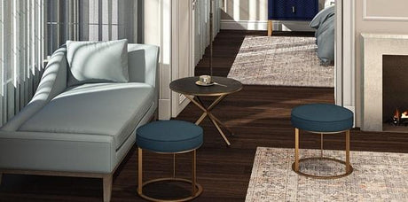 living room design with performance fabric, light blue upholstery performance fabric, navy upholstery performance fabric, chaise lounge upholstered  with performance fabric, traditional area rugs, bronze side table, navy stools, blue chaise lounge