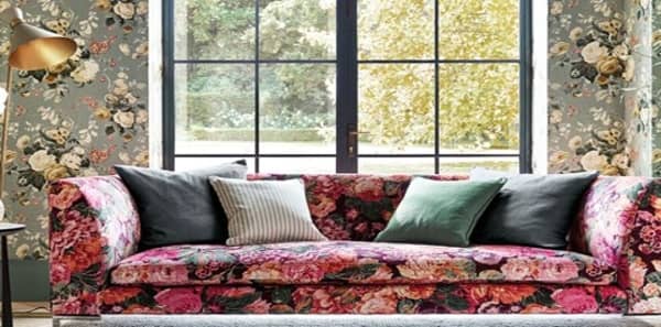 pink velvet sofa with pink floral roses, green floral wallpaper