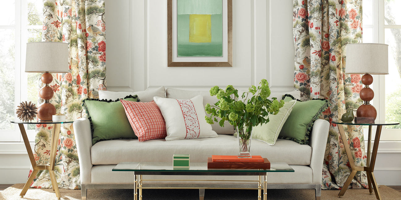 scalamandre, scalamandre fabric, designer fabrics, traditional floral drapery, floral drapery fabric, scalamandre designer items, white upholstered couch, wooden table lamps, green pink and white throw pillows, glass coffee table, traditional design