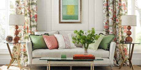 scalamandre, scalamandre fabric, designer fabrics, traditional floral drapery, floral drapery fabric, scalamandre designer items, white upholstered couch, wooden table lamps, green pink and white throw pillows, glass coffee table, traditional design