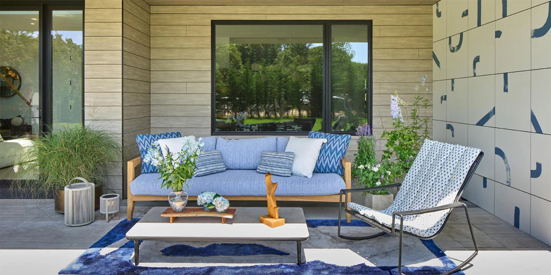 outdoor living room, outdoor fabric, blue outdoor fabric, outdoor pillows, outdoor rugs, holiday house hamptons, outdoor living, blue and white abstract outdoor rug, blue upholstered sofa, blue outdoor lounge chair, white coffee table, serving tray