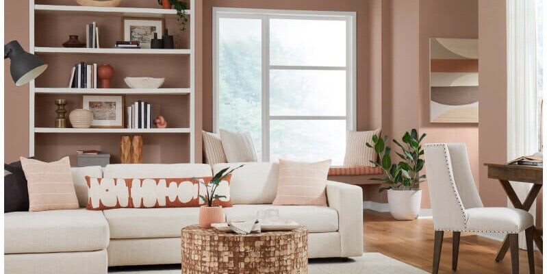 Sherwin Williams 2023 Color Of The Year Redend Point, Redend Point wall color, Redend Point toned throwpillows, pink coffee toned design, cozy living room design, cozy coffee tone with pink undertones, abstract pattern pillows, white upholstery sofa