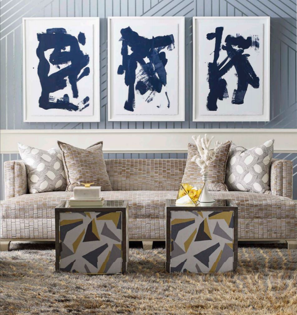 Noir Sofa grey white blue living room, beige upholstered sofa, designer furniture, brown area rug, blue striped wallpaper, grey throw pillows, beige throw pillows, geometric ottomans
