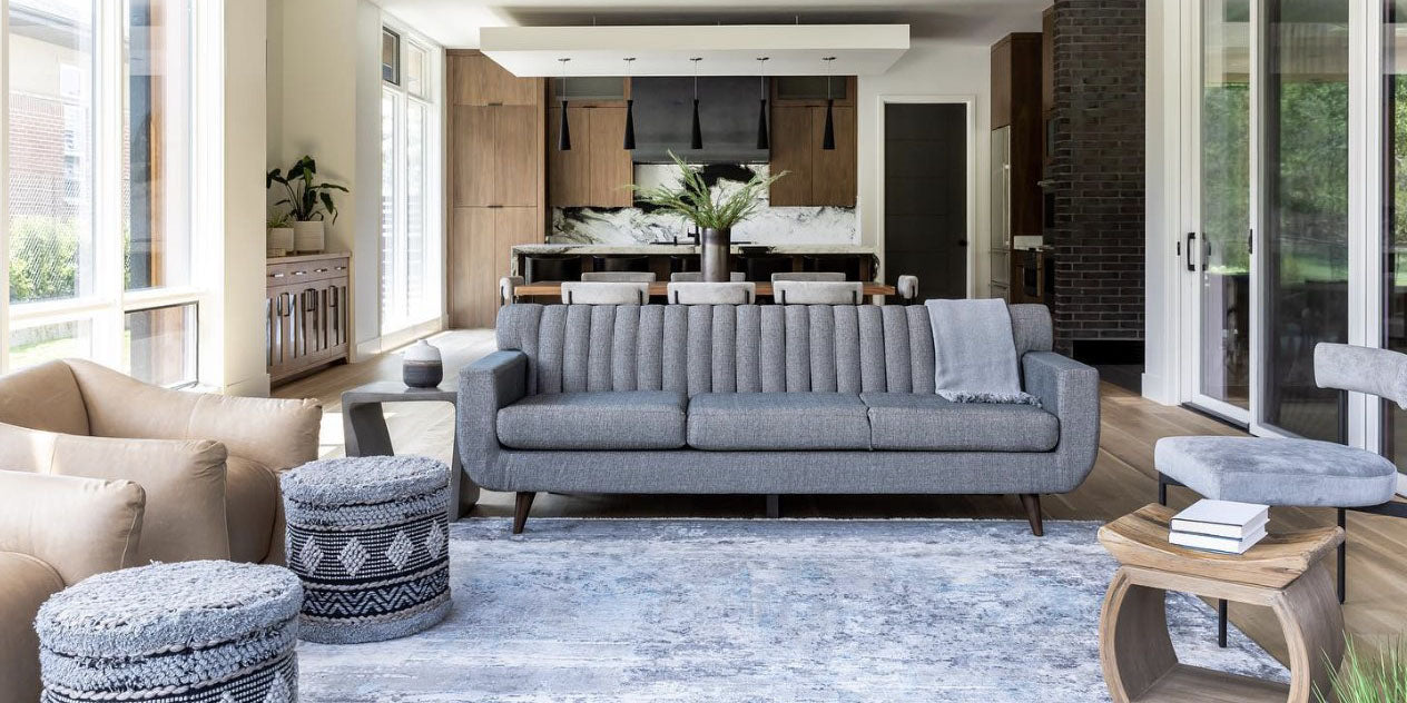 Surya rugs, blue rug, grey sofa, grey poufs