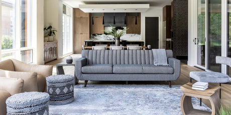 Surya rugs, blue rug, grey sofa, grey poufs