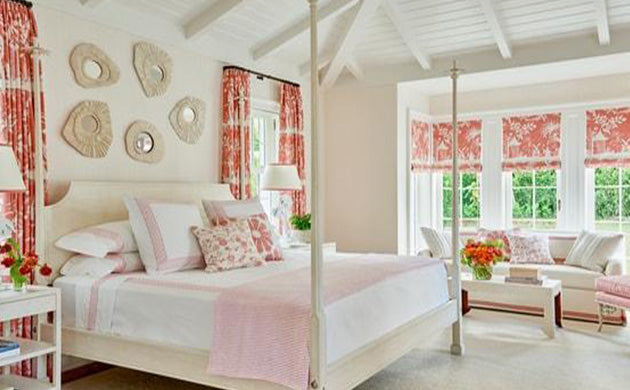 Pantone Living Coral Toile Bedroom by Phoebe Howard for Veranda Magazine, coral toile draperies, orange toile fabric, pink and white bedding, pink and white pillows, white upholstered sofa, pink and white throw pillow, white table lamps, wall art