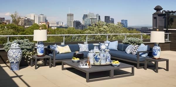 blue outdoor fabrics ,veranda les ensembliers brian mulroney home, outdoor living space, navy outdoor upholstery fabric, metal outdoor coffee table,  blue and white accent decor, blue and white table lamp, blue and white throw pillows, serving tray