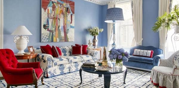 blue living room, blue and red living room, veranda, anthony baratta, blue and white sofa, ginger jar fabric, blue velvet upholstery, red velvet chair, blue floor lamp, white table lamp, blue and white geometric rug, black coffee table, red pillow