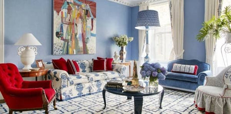 blue living room, blue and red living room, veranda, anthony baratta, blue and white sofa, ginger jar fabric, blue velvet upholstery, red velvet chair, blue floor lamp, white table lamp, blue and white geometric rug, black coffee table, red pillow