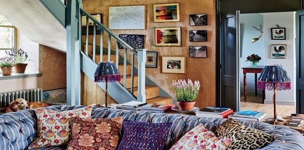 Cottagecore; Architectural Digest Amanda Brooks Cotswold Cottage; blue stripe sofa, burnt orange walls