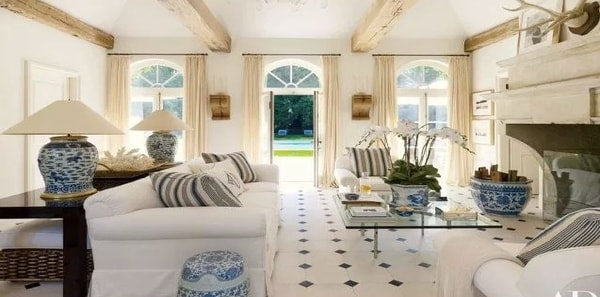 White sofa with blue and white accessories in Ralph Lauren's pool house