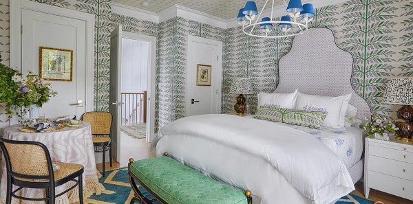 guest bedroom, green wallpapered bedroom, kerri pilchik Hamptons SHowhouse, Schumacher Thistle Ivory wallpaper, schumacher wallpaper, schumacher, green bench, blue pendant lighting, blue and white geometric area rug, upholstered bed frame, rattan