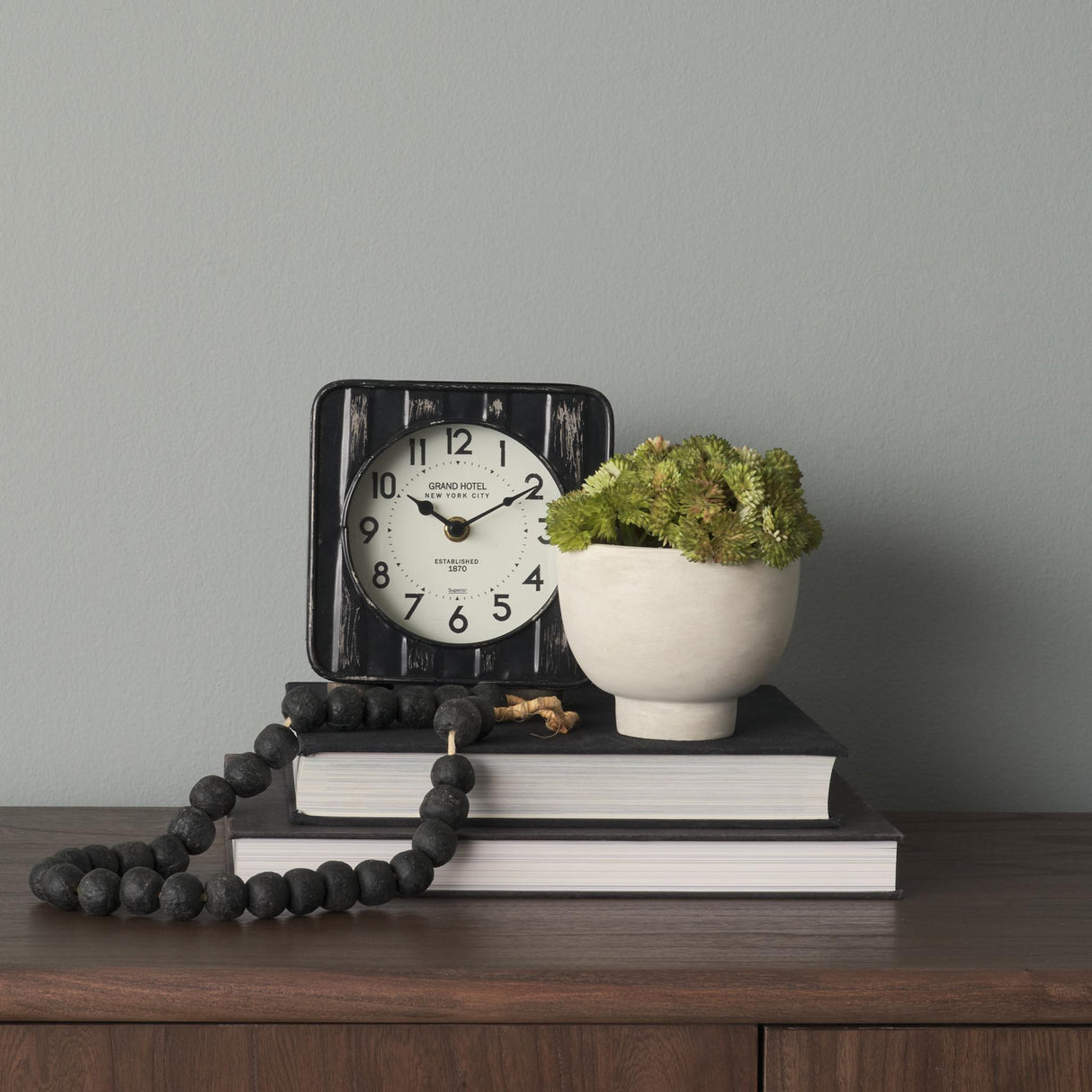 Mercana Karl 6.0L x 3.0W x 6.8H Rustic Black Iron Rounded Square Table Clock