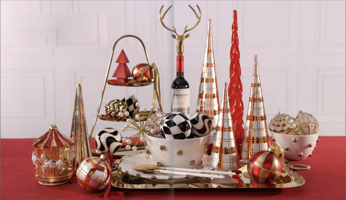 Festive holiday tabletop with gold trees, ornaments and a reindeer bottle stopper
